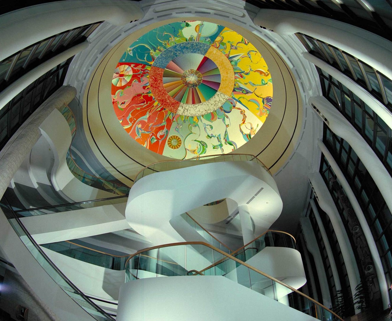 Interior of the Canadian Museum of History. Winding white staircases and a colorful oculus. 